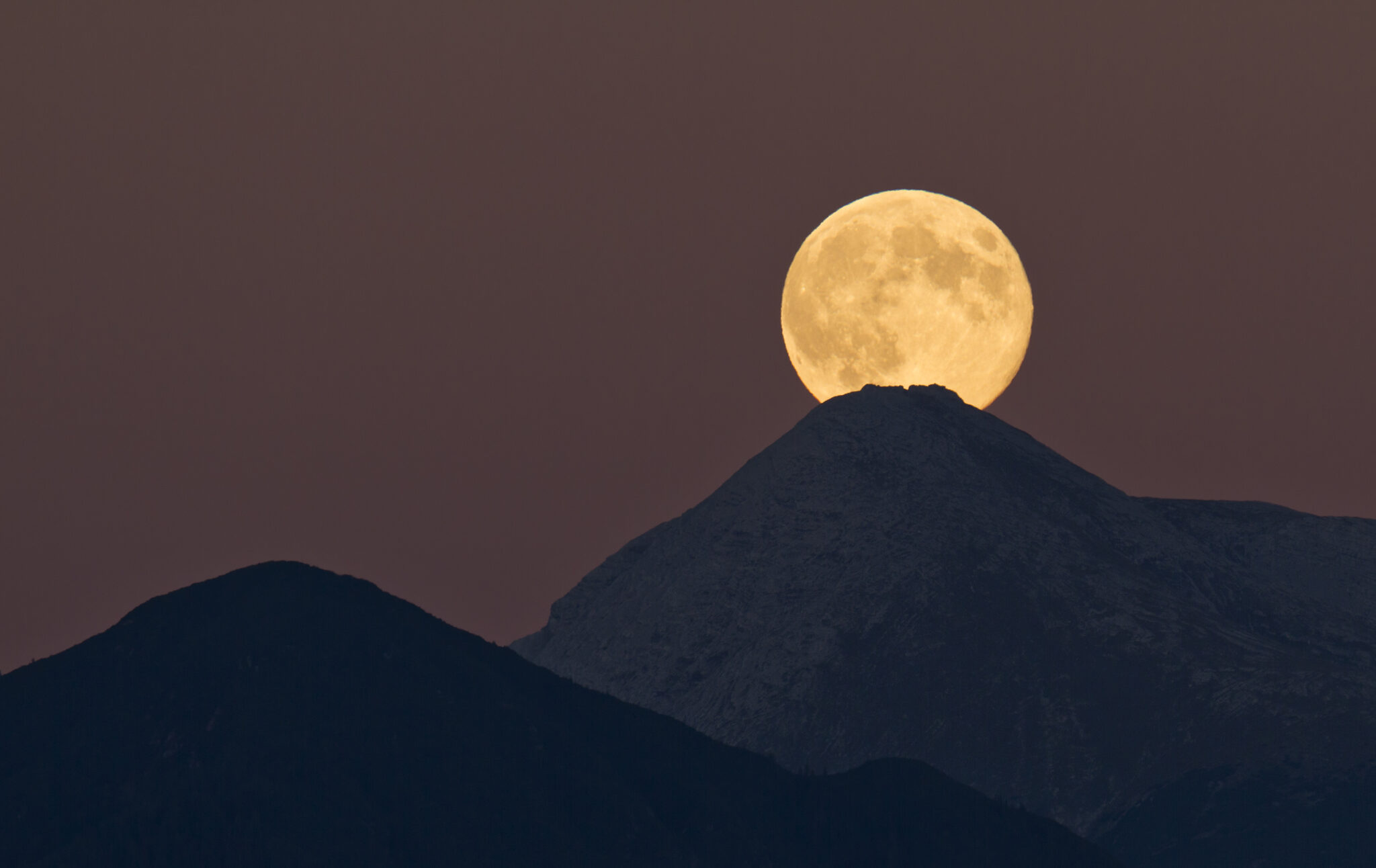 Full moon rising over austrian alps